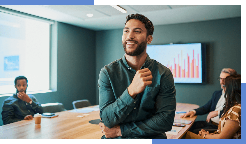 Smiling man leading a business meeting.