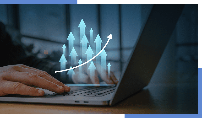 Hands typing on laptop with growth arrows.