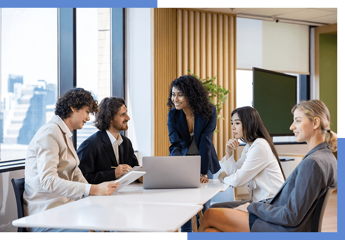 Business meeting with five people at table.