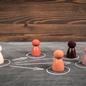 Colorful game pieces on chalkboard with arrows.